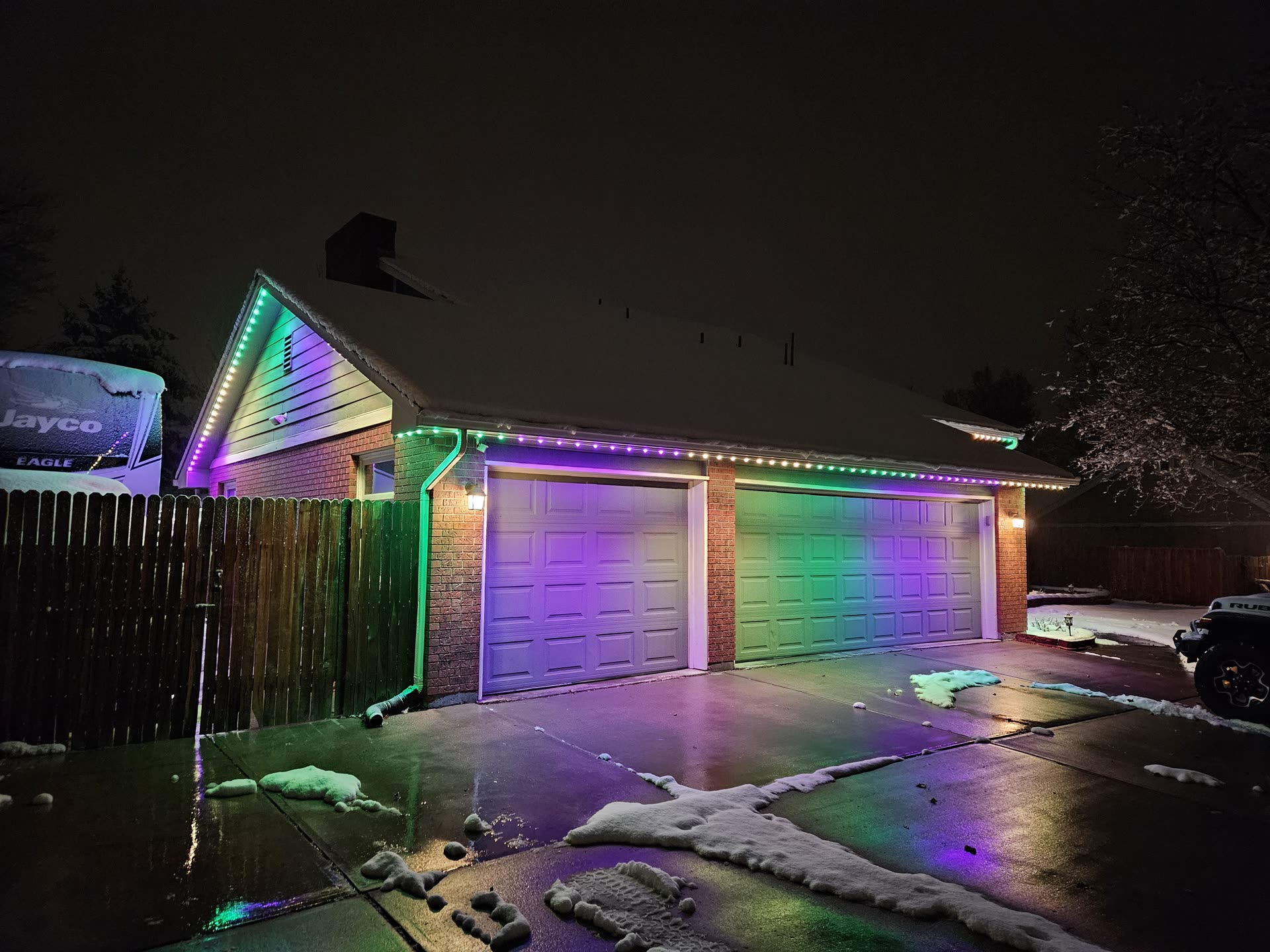 AFTERGLO permanent RGBW roofline lighting installed on a Utah home at night